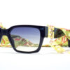 "Guess GU 7916 41B 55 sunglasses with black rectangular frames, blue gradient lenses, and yellow decorative chain links attached to a patterned fabric strap."