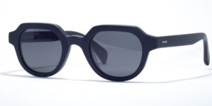 Ross & Brown Amsterdam 112 sunglasses featuring unique octagonal matte black frames, dark gray lenses, and a minimalist contemporary design.