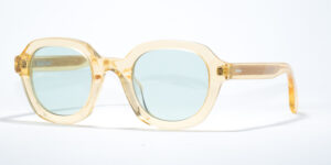 Ross & Brown Habana V 219 sunglasses with translucent yellow round frames, light blue lenses, and delicate gold detailing on the hinges