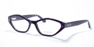 Guess GU 2968 prescription glasses featuring an oval cat-eye frame design, available in two colors: translucent pink and classic black with crystal embellishments. These frames showcase a feminine style with the Guess logo on the temples, adding a touch of elegance.